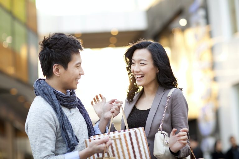 Excited young woman receiving a surprise gift from boyfriend