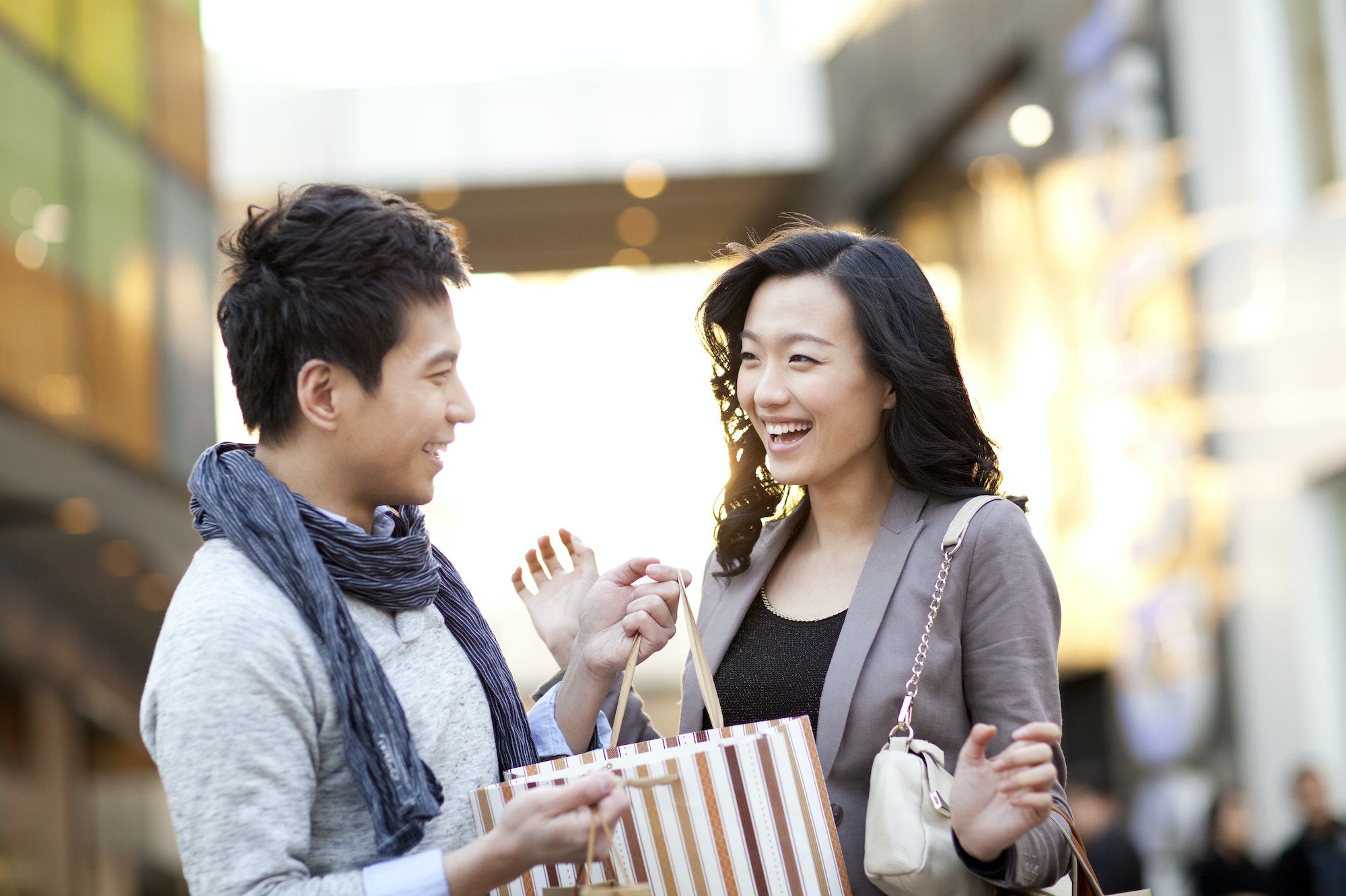 Excited young woman receiving a surprise gift from boyfriend