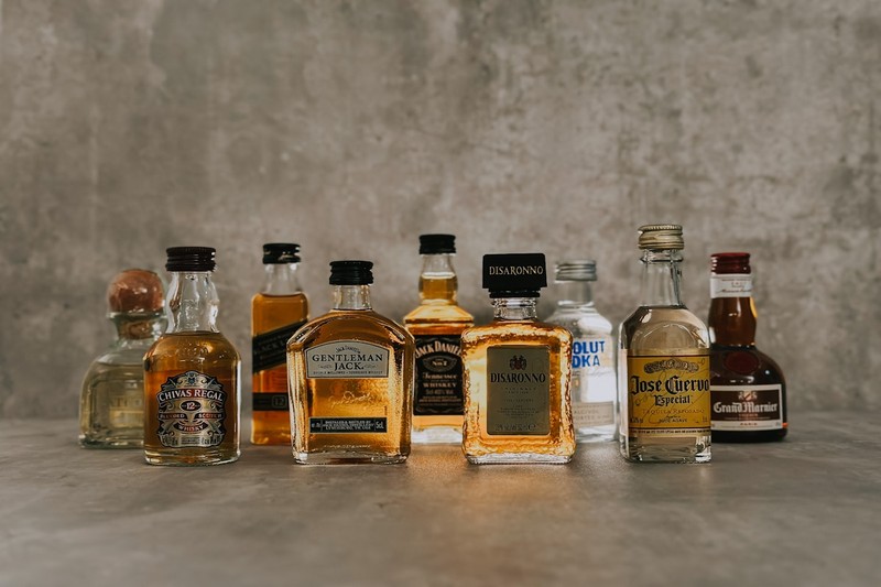 Assorted mini liquor bottles of craft spirits tied with a ribbon as party favors