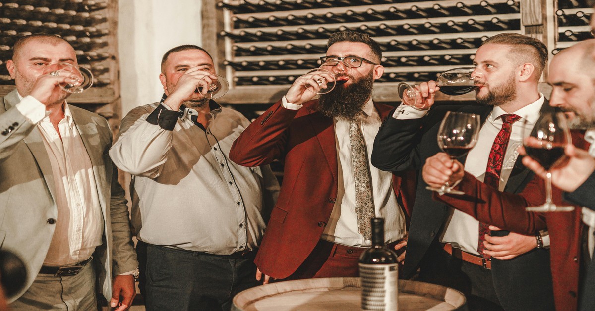 Bachelor party crew at airport Group of men laughing with luggage at airport terminal