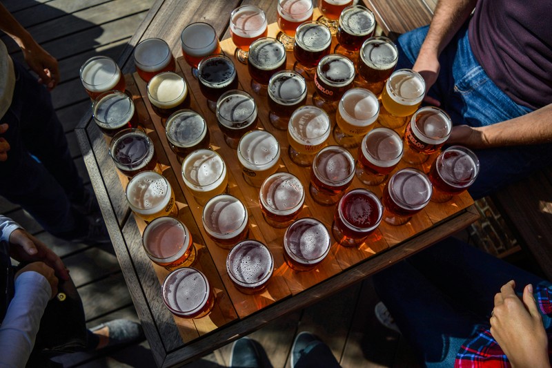 Group of men tasting craft beer during a brewery tour for a daytime bachelor party