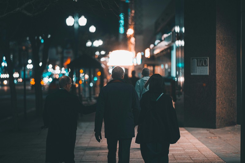 Group of men walking together at night during a bachelor party