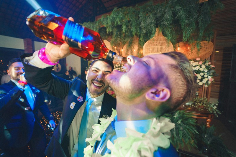 A group of men celebrating at a nightclub during a bachelor party