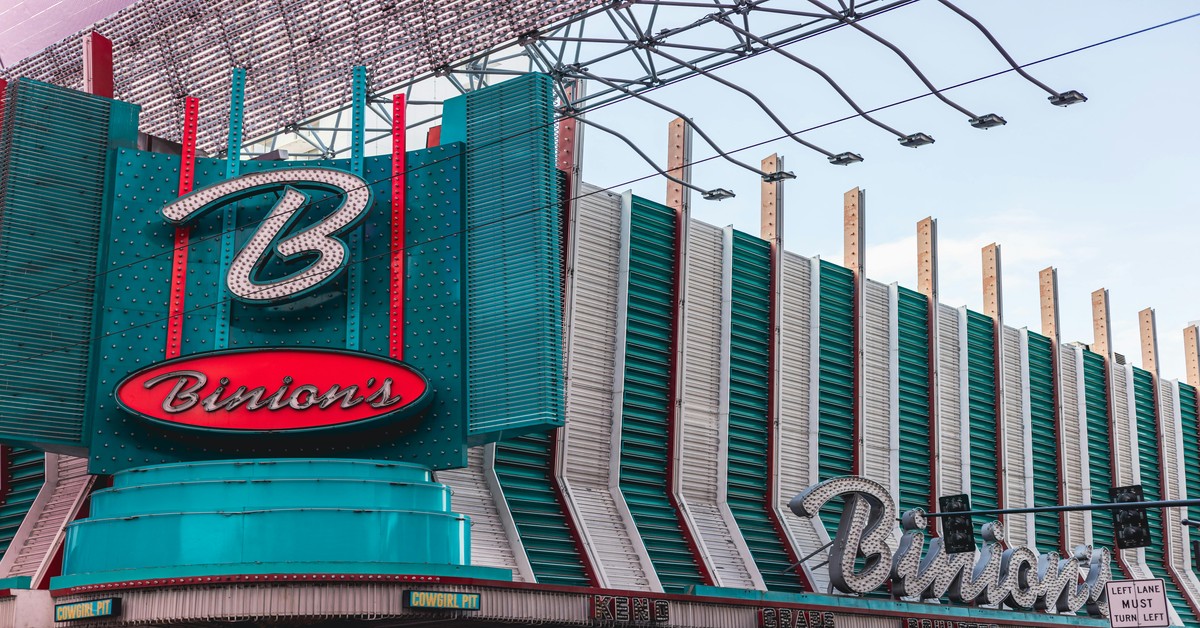 bright neon sign on a Las Vegas strip club building at night