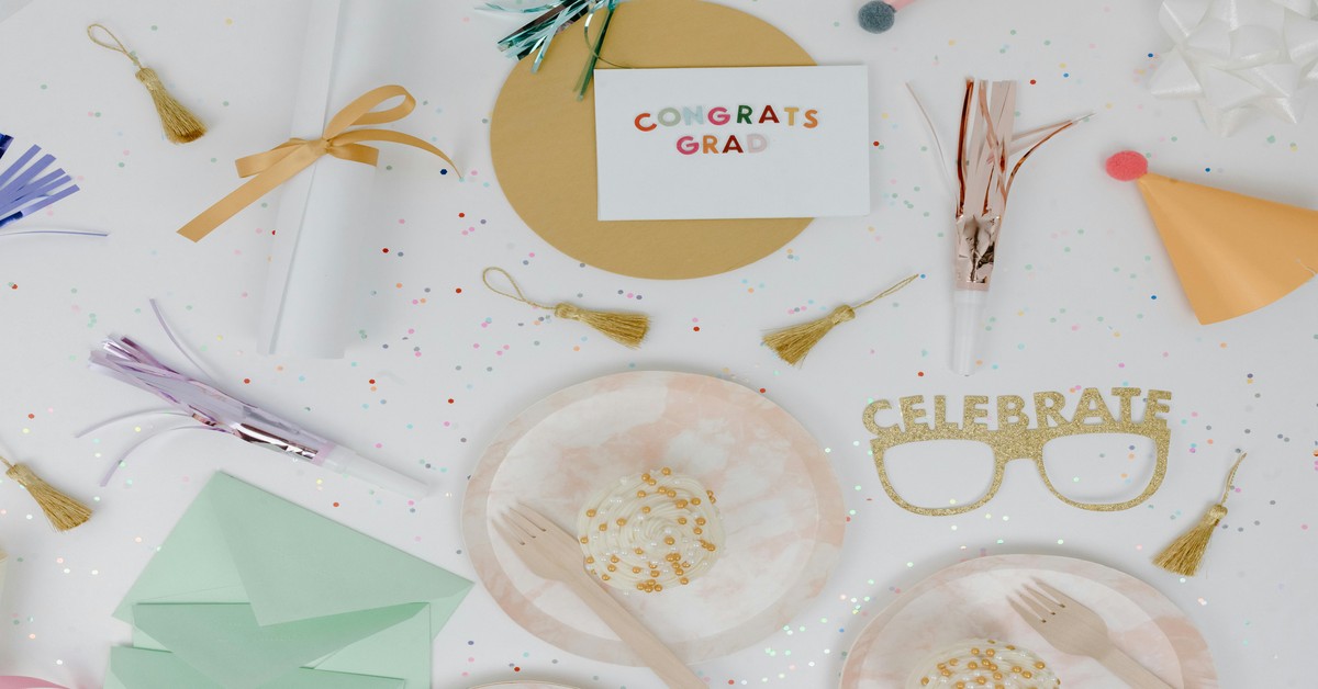 A table with bachelorette party decorations including a Bride Tribe banner and tassel garlands
