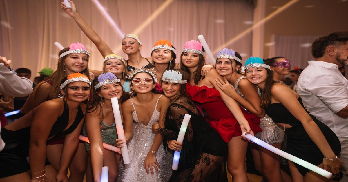 A group of women celebrating a bachelorette party at a VIP table in a nightclub