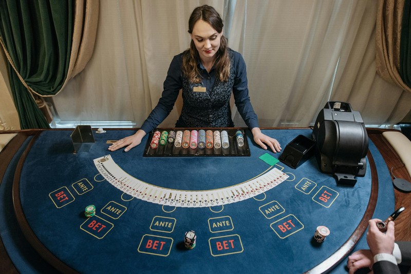 A blackjack table with cards dealt and chips placed for a casino party game
