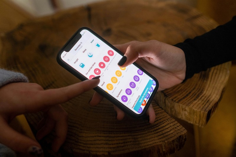 Smartphone screen displaying a budget tracking app with shared expenses for a group trip