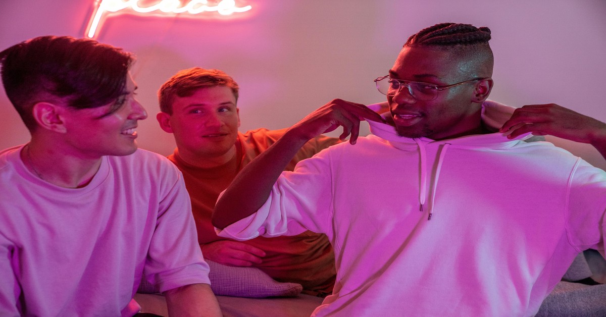 Group of friends laughing together in an escape room lobby