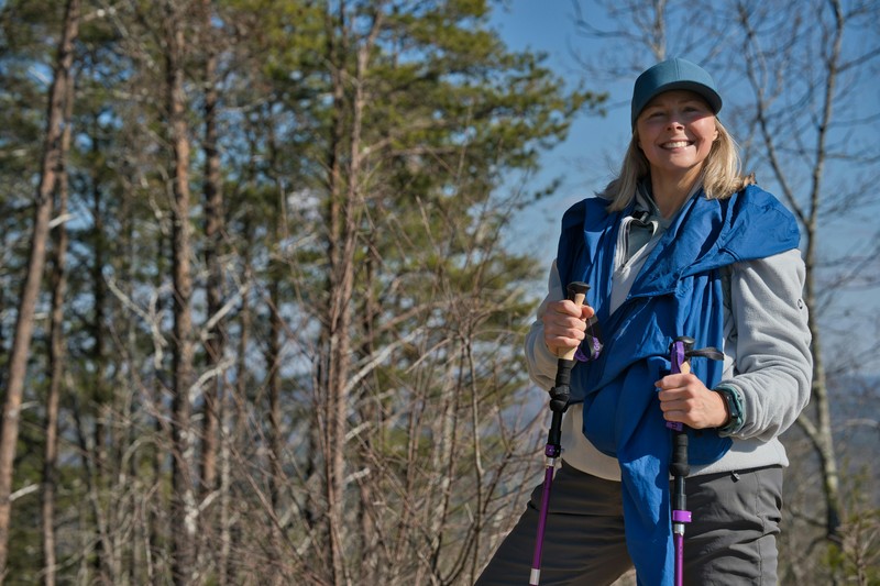 Essential Hiking Gear for a Bachelorette Party Women hiking with trekking poles wearing layered outdoor clothing