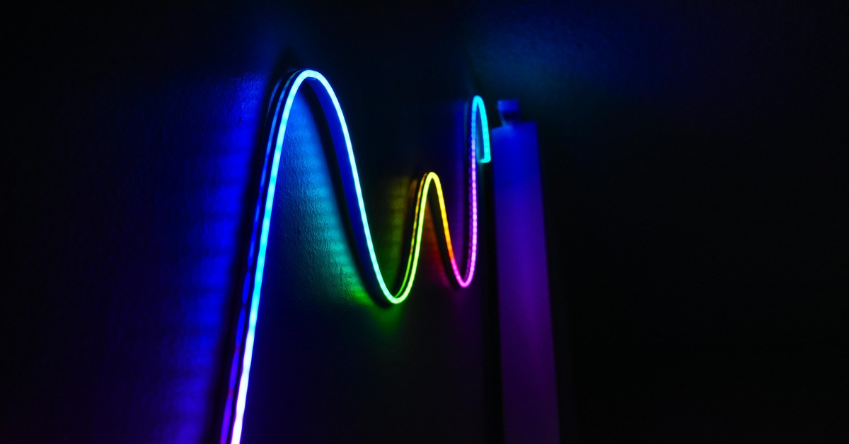 Colorful LED strip lights attached to a hotel mirror creating a vibrant party atmosphere