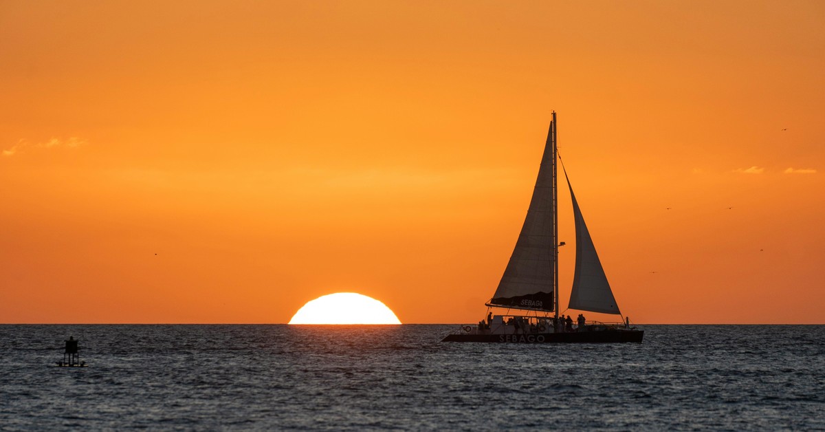 Sunset over the Gulf of Mexico from Mallory Square in Key West with a crowd gathered to watch street performers