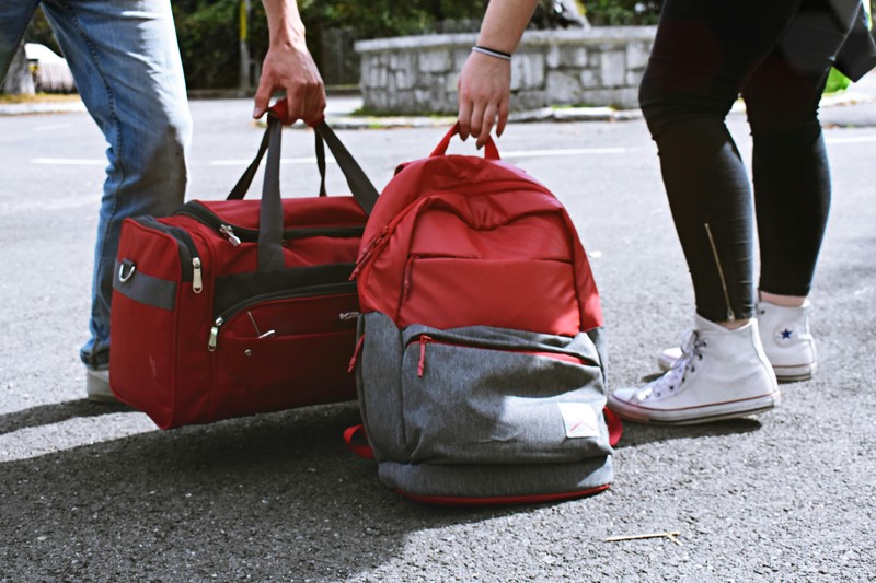 Soft collapsible duffel bags packed neatly into a car trunk for group travel