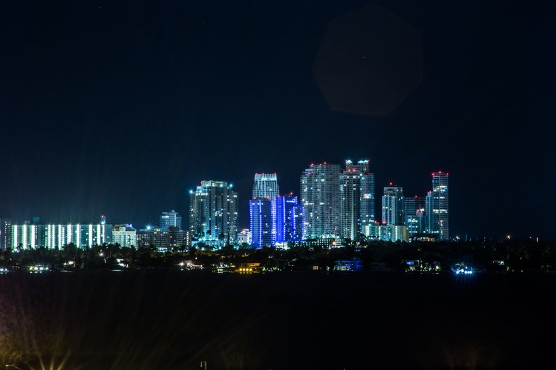 Night view of the Brickell skyline in Miami with illuminated high-rise buildings