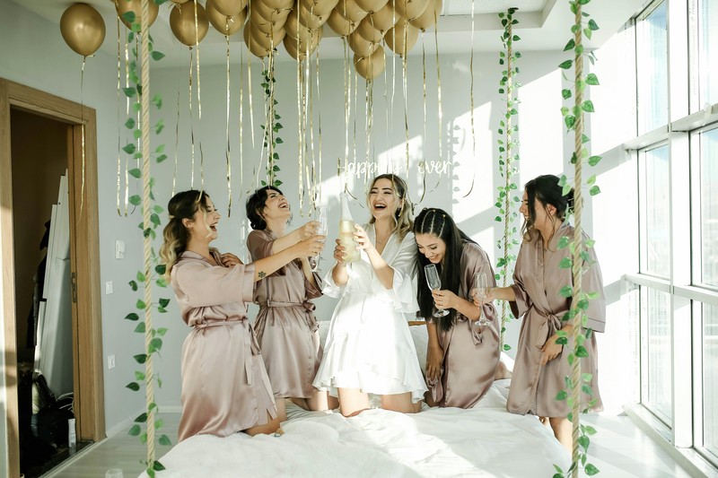 Group of women toasting with champagne glasses at a Miami hotel pool