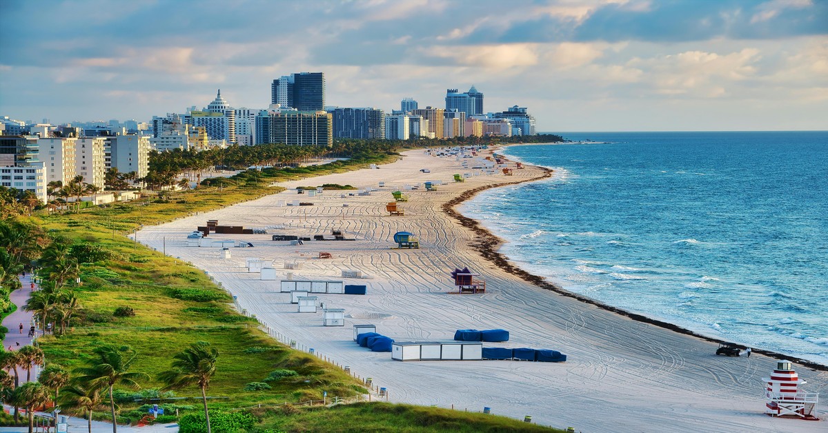 Aerial view of Miami South Beach with turquoise water, white sand, and pastel buildings