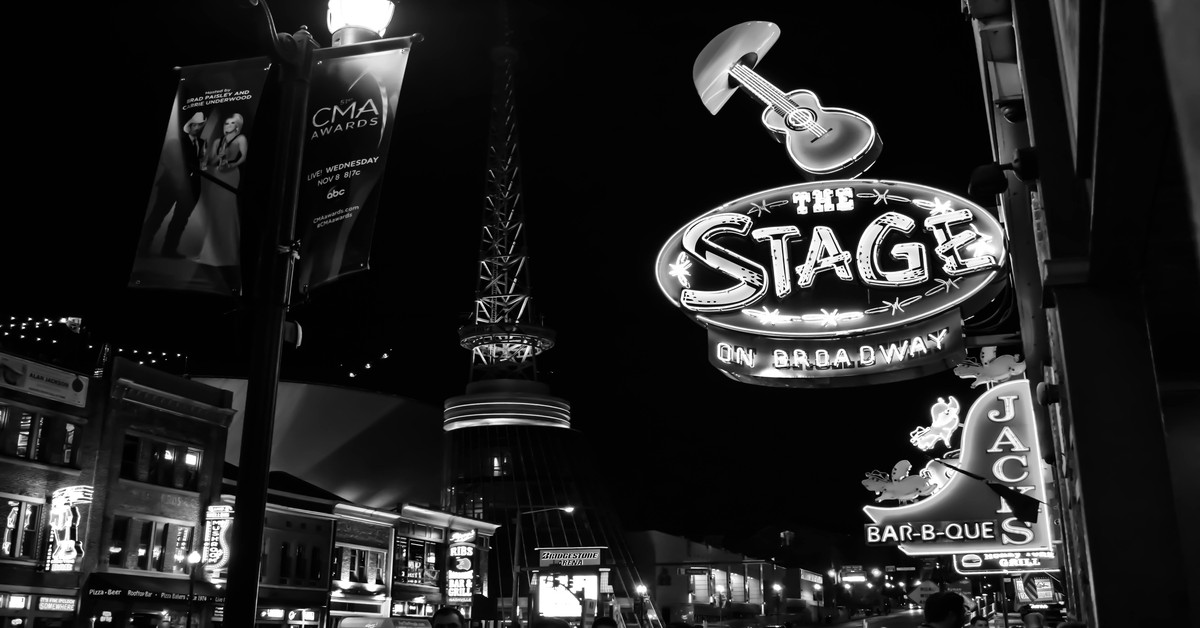 Nashville skyline at night with neon lights on Broadway street