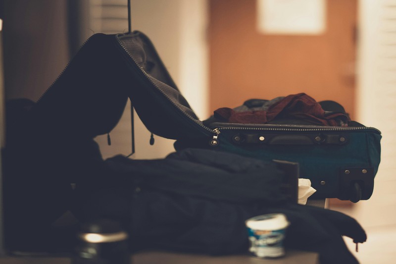 Packed Gear for Bachelor Party Road Trip A packed suitcase and soft-sided cooler ready for a bachelor party road trip