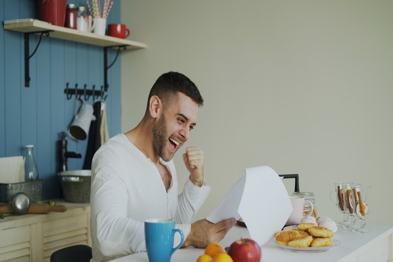 Man holding note cards while practicing a speech at home