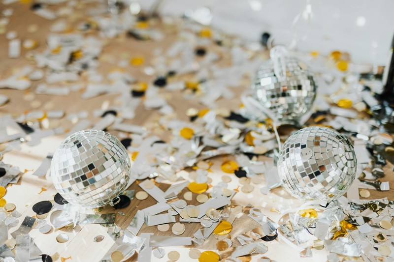 Rechargeable disco ball projecting colorful lights on hotel ceiling and walls