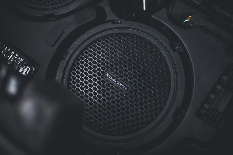 Close-up of a portable speaker woofer and passive radiator showing bass components